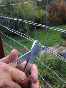 Crimping tool in action fastening together two strips of mesh. The join makes an amazingly strong seam!